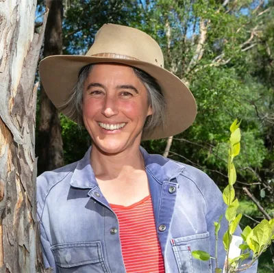 Vicky Shukuroglou, in front of a eucalypt
